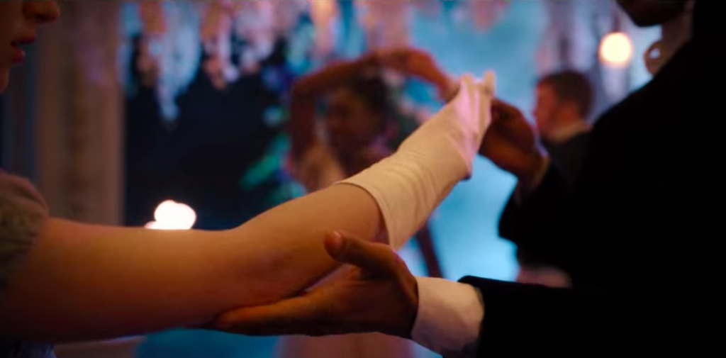 Simon taking Daphne's gloves off.
