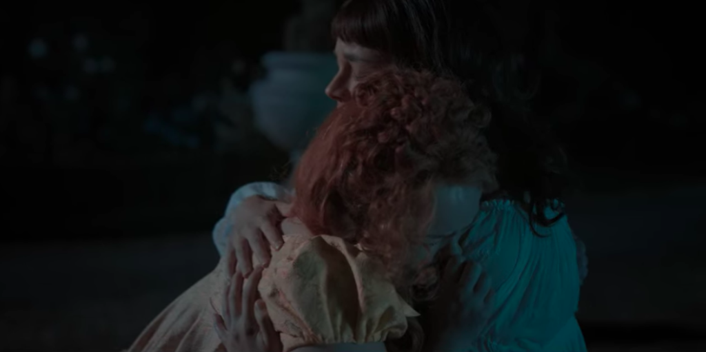 Eloise embraces a sobbing Penelope in the garden.