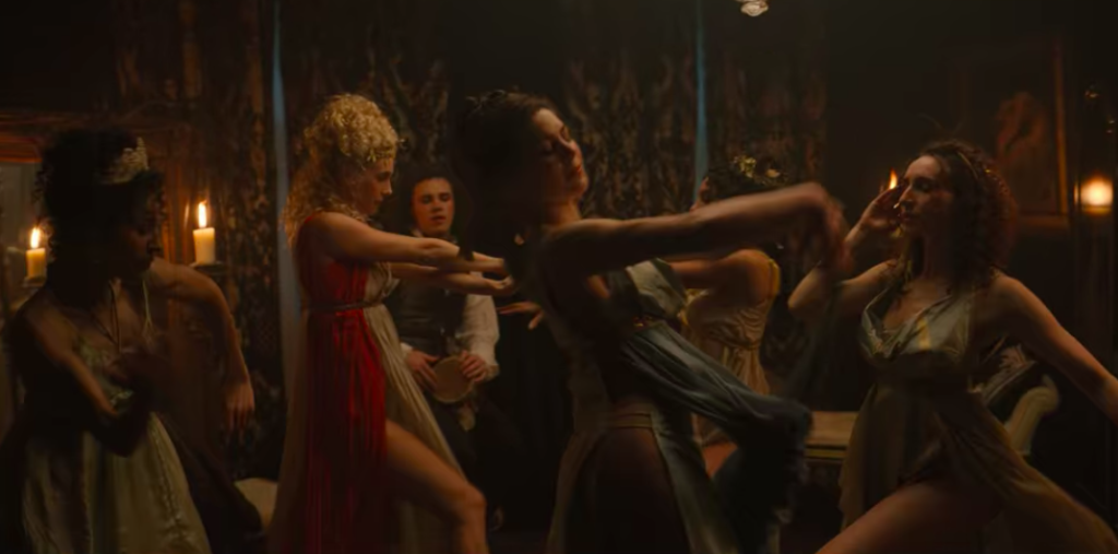 Women in loose fitting grecian dresses, dancing around.