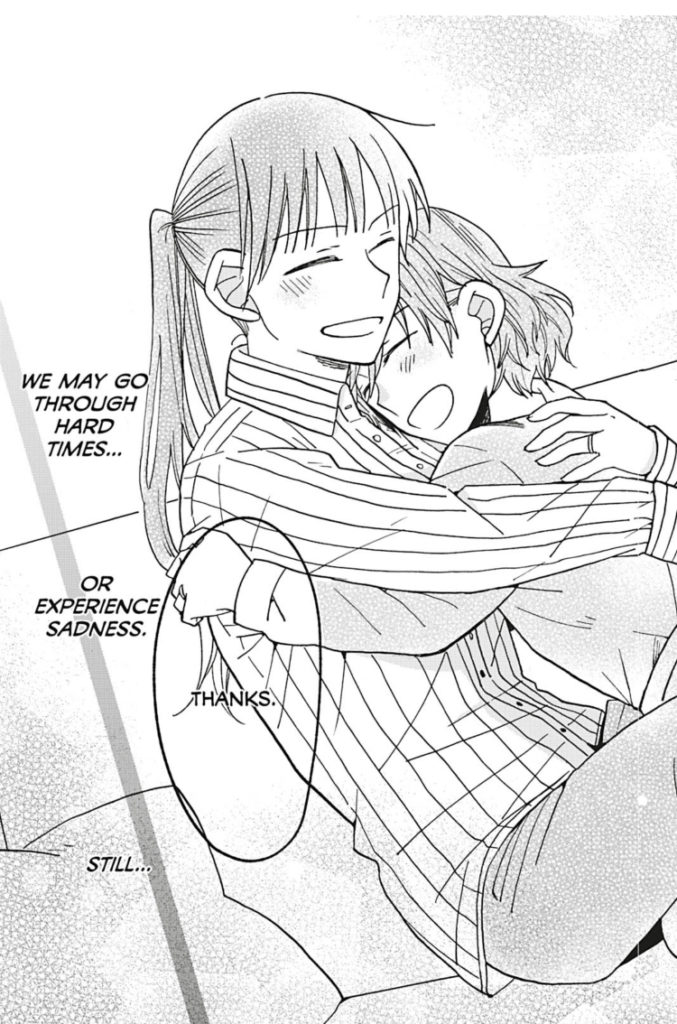 Maekawa and Shimizu embrace, with the caption: "We may go through hard times... or experience sadness. Still..."