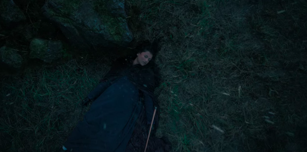 Kate lays unconscious on the ground after being thrown by her horse and hitting her head on a rock.