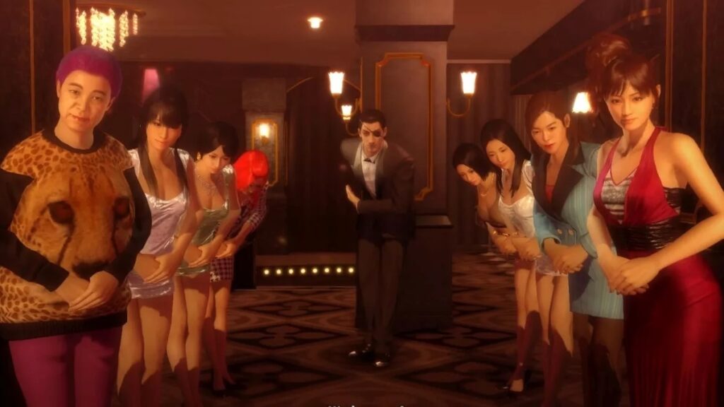 Goro Majima bows as he is flanked by the hostesses in this club.