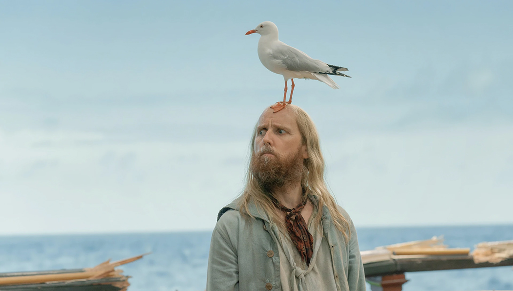Buttons staring wildly, with Karl the Seagull perched atop his head.