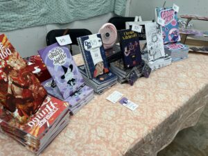 Spread of POMEpress books at the 2024 Lone Star Zine Fest